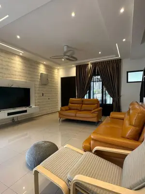 a living room with couches and a flat screen tv at Adik Aisyah cameron semi-D goleden hill homestay in Brinchang