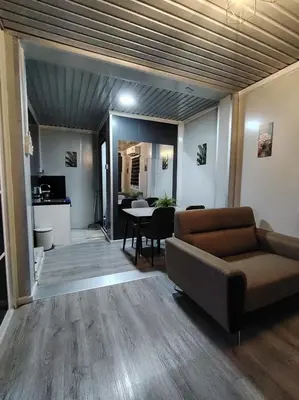 a living room with a couch and a table at ZR Homestay in TanjongMalim