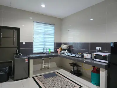 a kitchen with a sink and a counter with a microwave at HOMESTAY KLeMERU E POH in Chemor