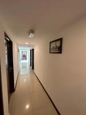 a hallway of a building with a picture on the wall at Georgetown Hotel in George Town