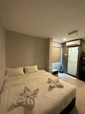 a bedroom with a white bed with bows on it at Georgetown Hotel in George Town