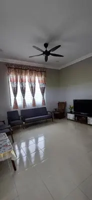 a living room with a couch and a ceiling fan at Inap hujung kampung in Penaga