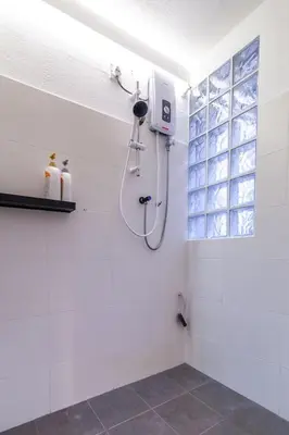 a shower in a white bathroom with a window at Unique Design House, 2BR House - Near Ipoh Local Foodies in Ipoh