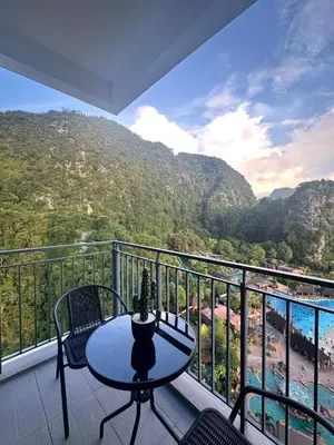 a table and chairs on a balcony with a view at Sunway Onsen Suites in Tambun