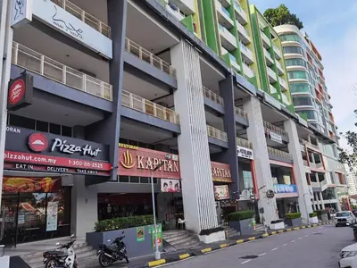 a building on a street with motorcycles parked in front at 2BR Lively City View Family Suite#Airport in Bayan Lepas