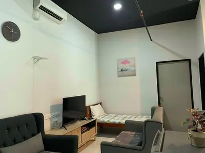 a living room with a bed and a mirror at 2BR Airport Panoramic View Family Suite in Bayan Lepas