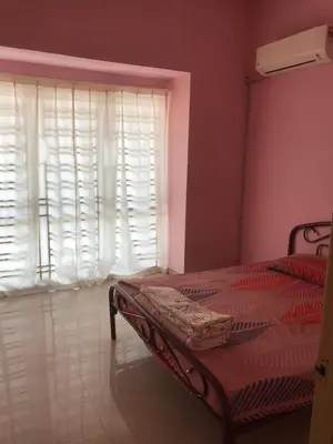 a bedroom with a bed and a window with white blinds at Batu Kawan Home in Simpang Ampat