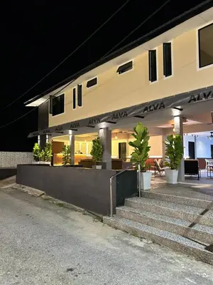 a building with stairs and plants in front of it at Alva Boutique Chalet Pangkor in Pangkor