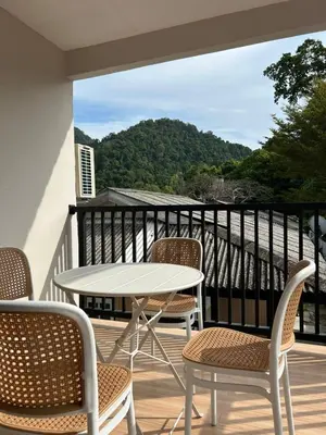 a patio with a table and chairs on a balcony at Alva Boutique Chalet Pangkor in Pangkor