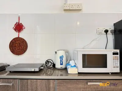 a kitchen counter with a microwave and a coffee maker at Taiping Crystal Creek Condo Pool Gym Netflix in Taiping