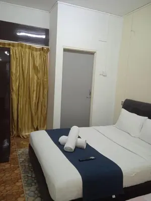 a bedroom with a bed with two towels on it at Cool view budget hotel in Cameron Highlands