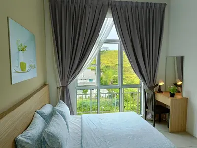 a bedroom with a bed and a window and a desk at Family Suite at Cameron Golden Hills in Brinchang