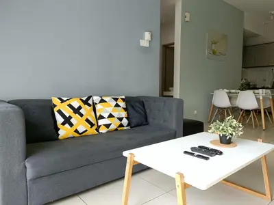 a living room with a couch and a table at Family Suite at Cameron Golden Hills in Brinchang