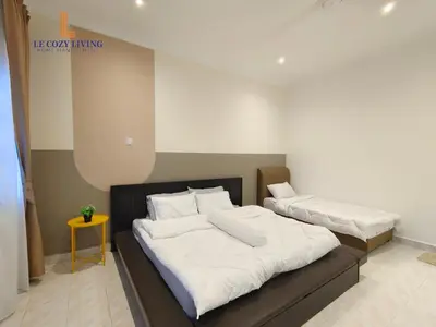 a bedroom with two beds with white sheets at The Cozy Retreat House at Bukit Mertajam in Bukit Mertajam