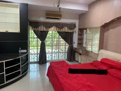 a bedroom with a red bed and a large window at Thind's Place in Kamunting