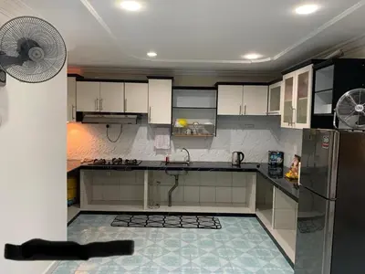a kitchen with a refrigerator and a fan at Thind's Place in Kamunting