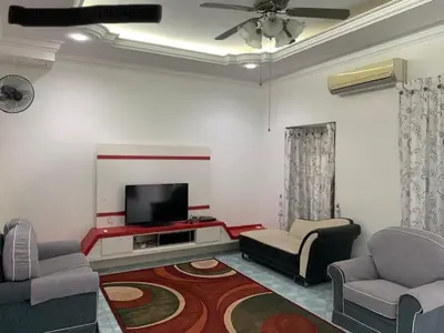 a living room with two chairs and a flat screen tv at Thind's Place in Kamunting