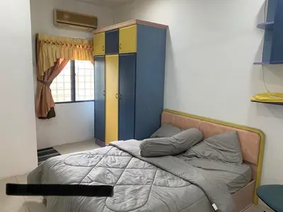 a bedroom with a bed and a blue and yellow cabinet at Thind's Place in Kamunting