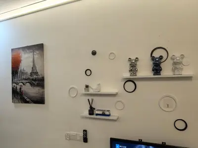a wall with shelves and clocks on it at Summer Cozy Studio Room in Perai