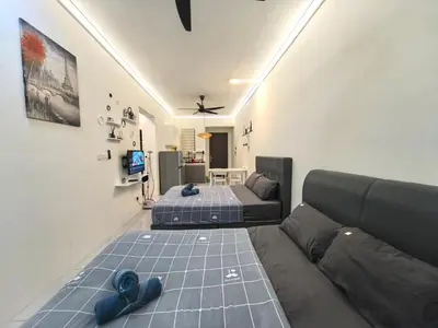 a living room with two beds and a couch at Summer Cozy Studio Room in Perai