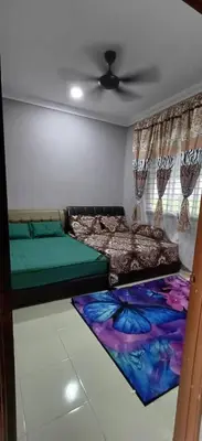 a room with two beds and a ceiling at d'esaku homestay in Penaga