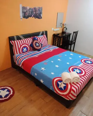 a bedroom with a bed with captain america sheets at Elephant House Hotel in George Town