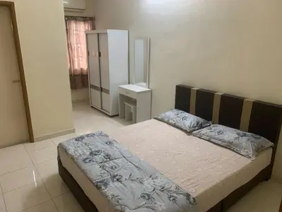 a bedroom with a bed in a room at TD Homestay in Ipoh