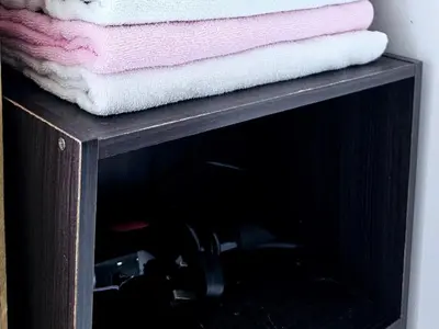 a wooden cabinet with towels on top of it at 8\u697c\u6c11\u5bbf Enjoy the Paddy Field View in Sekincan