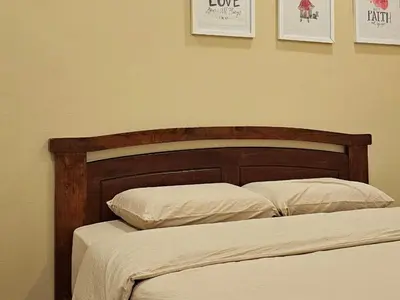 a bed with a wooden headboard and two pillows at \u65e5\u5f0f10\u697c7\u53f7 Comfy Japanese Style Unblocked Paddy View in Sekincan