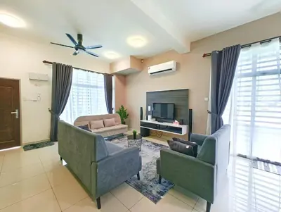 a living room with two chairs and a television at Premium Homestay - Tol Taiping in Kamunting