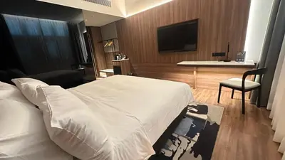 a hotel room with a bed and a chair and a television at Citadines Connect Bertam Georgetown Penang in George Town