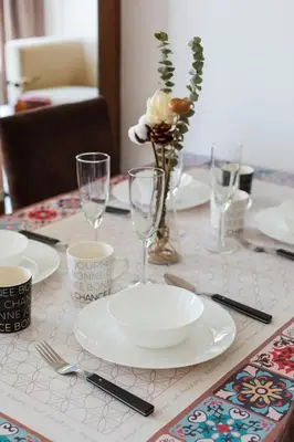 a table with plates and glasses on a table at Georgetown Mansion One Apartment by Jere Penang Gleneagles Gurney in George Town