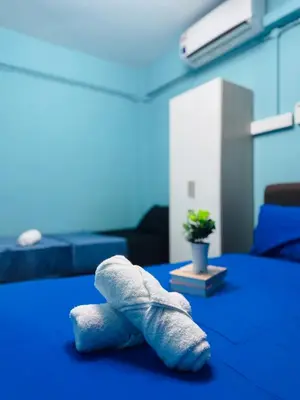 a towel laying on a bed in a room at Apartment in gelugor usm in Gelugor