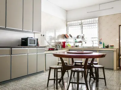 a kitchen with a wooden table and some chairs at Lodge 22, 5 min walk to Adventist & Pulau Tikus Market in George Town