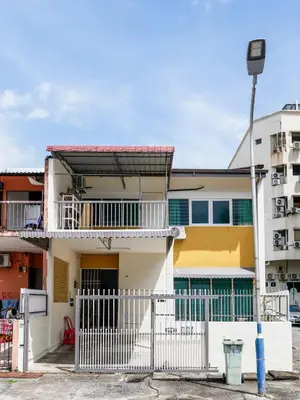 a building with a white fence in front of it at Lodge 22, 5 min walk to Adventist & Pulau Tikus Market in George Town