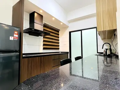 a kitchen with a black counter top and a refrigerator at SunshineResidence 5pax Near Georgetown in Ayer Itam