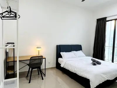 a bedroom with a bed and a desk with a teddy bear on it at SunshineResidence 5pax Near Georgetown in Ayer Itam