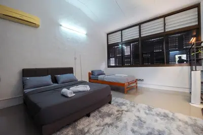 a living room with a bed and a couch at Hutton Haven by MyStay in George Town