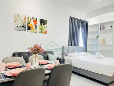 a bedroom with a table and chairs and a bed at Venus Suite in Setia Alam 2 in Gua Sai