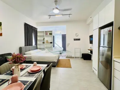 a large living room with a bed and a kitchen at Venus Suite in Setia Alam 2 in Gua Sai