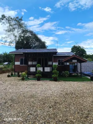 a small house with a gambrel roof at Homestay Teratak D'Desa in Gua Sai