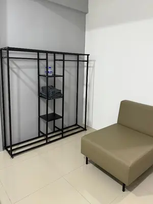 a room with a couch and a shelf at Modern & Cozy Home Stay in Kampar