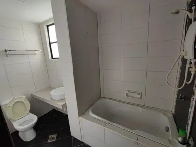 a bathroom with a tub and a toilet and a sink at 3B2BR Marina Height Seaview room Rose in Lumut