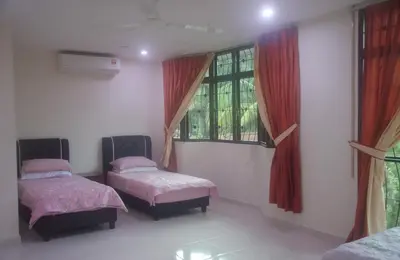 a room with two beds and two windows at Kulim LakeView Homestay for Msliims Only in Kulim