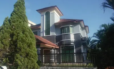 a large house with a fence and trees at Kulim LakeView Homestay for Msliims Only in Kulim