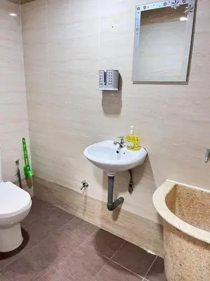 a bathroom with a sink and a toilet and a tub at Menglembu Hill Home Stay in Ipoh