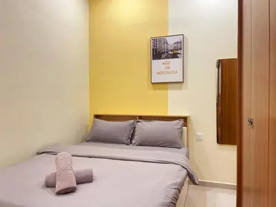 a bedroom with a bed with a picture on the wall at Vintage CoLiving 2Storey Haus in Bukit Mertajam