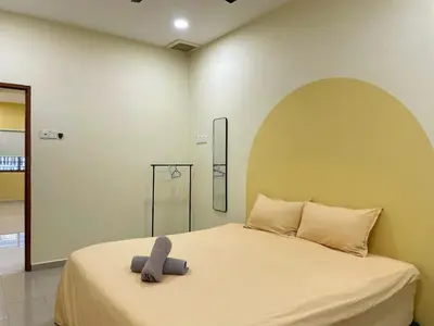a bedroom with a bed with a gray object on it at Vintage CoLiving 2Storey Haus in Bukit Mertajam