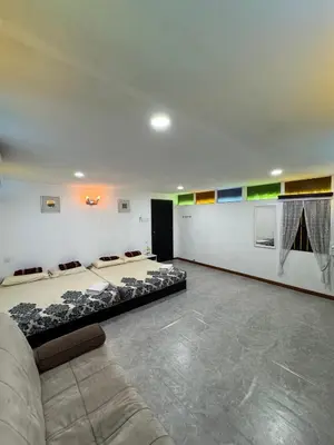 a room with two beds and a couch in it at Rumah Inap Kampung Agong Tempua in Penaga