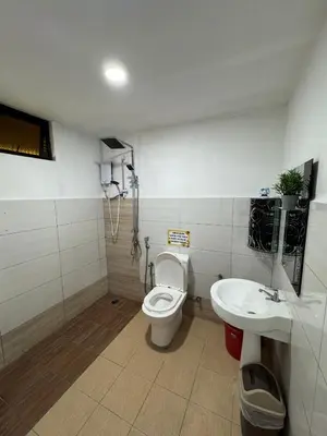 a bathroom with a toilet and a sink at Rumah Inap Kampung Agong Tempua in Penaga